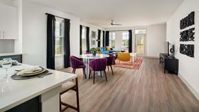 Austin townhouse for rent - A modern dining room with a white table and purple chairs.