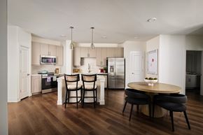 Carrollton apartment for rent - A modern kitchen with a dining table and chairs.