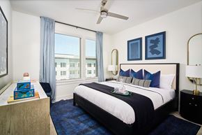 Carrollton apartment for rent - A bedroom with a large bed and a ceiling fan.