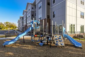 Cleveland apartment for rent - Family-friendly play area with colorful slides, interactive equipment, and a safe outdoor space for recreation.