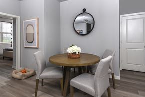 Kyle apartment for rent - A dining room with a round table and grey chairs.