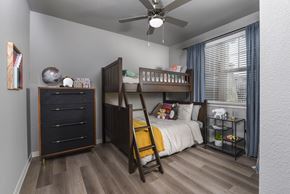 Kyle apartment for rent - A bedroom with a bunk bed and a dresser.