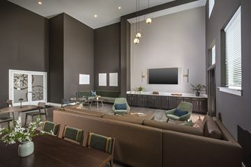 Charlotte apartment for rent - A living room with a brown couch and green chairs.