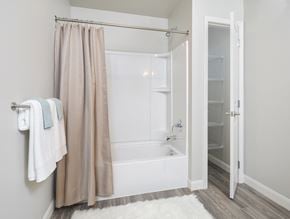 Tiffin apartment for rent - A white bathroom with a shower curtain and a white towel hanging on the wall.