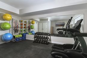 Cleveland apartment for rent - Modern fitness center featuring cardio equipment, large windows, and a bright, comfortable environment for daily workouts