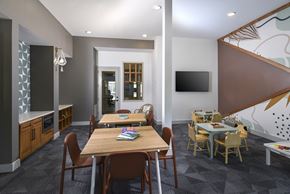 Mckinney apartment for rent - A dining room with a long table surrounded by chairs.