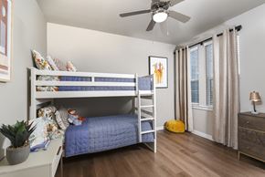 Converse apartment for rent - Secondary bedroom featuring a bunk bed setup, neutral finishes, and nearby windows.