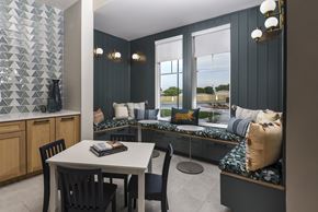 Converse apartment for rent - Dining nook with built-in bench seating, accent wall detailing, and a small table set near large windows.