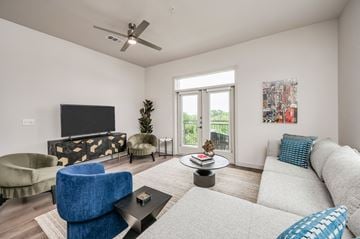 Houston apartment for rent - A living room with a blue chair and a white couch.