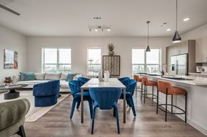 Houston apartment for rent - an open concept living room and kitchen area with a dining table and chairs and a kitchen island