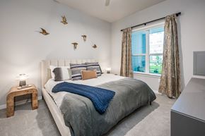 Houston apartment for rent - a bedroom with a large bed and a large window