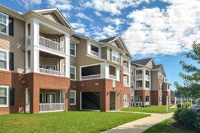 Raleigh apartment for rent - an apartment building with a sidewalk in front of it
