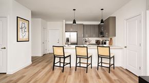 Austin apartment for rent - A kitchen with a wooden floor and a painting on the wall.