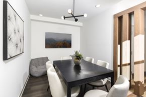 Columbus apartment for rent - Stylish meeting space featuring a central table, upholstered chairs, and contemporary lighting with clean, modern finishes.