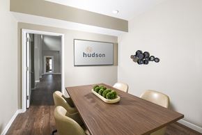 Selkirk apartment for rent - A dining room with a wooden table and chairs and a framed sign that says "hudson".