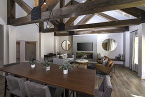 Charlotte apartment for rent - A modern dining room with a wooden table and chairs.