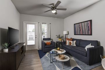 Charlotte apartment for rent - A living room with a blue couch and a television.