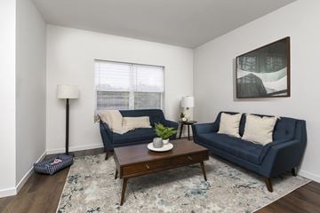 Cleveland townhouse for rent - A living room with a blue couch and a coffee table.