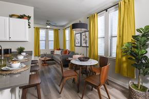 Converse apartment for rent - A modern dining room with a round table and chairs.