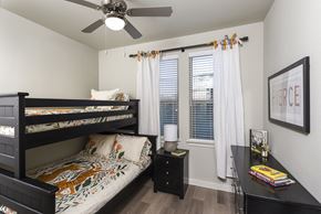 Converse apartment for rent - A bedroom with a bunk bed and a desk.