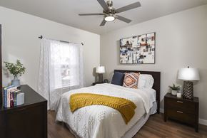 Cleveland apartment for rent - Inviting bedroom with contemporary décor, warm wood-style flooring, and abundant natural light