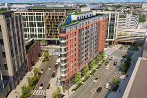 Washington apartment for rent - An aerial view of The Emblem modern apartment community with multi-story buildings, landscaped sidewalks, and walkable streets in a vibrant city setting.