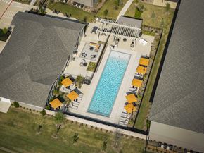 Sherman apartment for rent - An aerial view of a pool surrounded by orange unbrellas and ample seating
