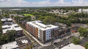 Irvington apartment for rent - A city street with a large building in the middle.