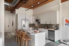 Wakefield apartment for rent - A modern kitchen with white cabinets and a wooden ceiling.