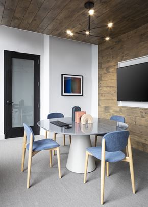 Wakefield apartment for rent - A modern dining room with a glass table and blue chairs.