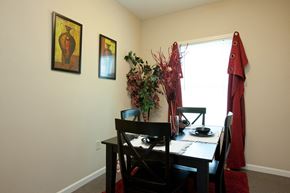 Evansville apartment for rent - A dining room with a table set for two and a vase of flowers on the table.
