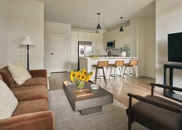 Las Vegas apartment for rent - A living room with a brown couch and a grey coffee table.
