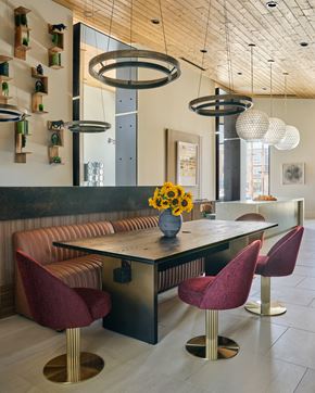 Las Vegas apartment for rent - A modern room with a long table and red chairs.