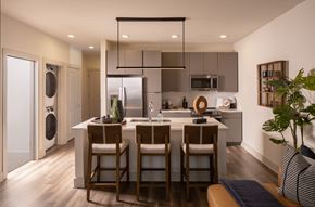 Charlotte apartment for rent - A modern kitchen with a dining table and chairs.