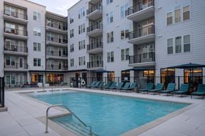 Charlotte apartment for rent - A swimming pool in front of apartment buildings.