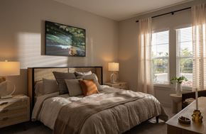 Venice apartment for rent - A bedroom with a large bed, a nightstand, and a painting on the wall.