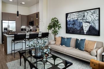 Charlotte apartment for rent - A living room with a couch, a coffee table, and a painting on the wall.