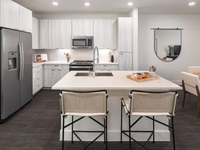 Austin apartment for rent - a kitchen with a large island with three stools