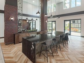 Houston apartment for rent - A modern kitchen with a long black table and chairs.