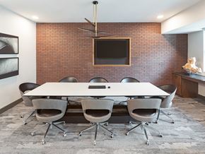Houston apartment for rent - A conference room with a white table and chairs.