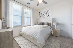 San Antonio apartment for rent - A bedroom with a large bed and a ceiling fan.