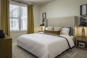Del Valle apartment for rent - A bedroom with a large bed and a window with curtains.
