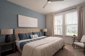 Kissimmee apartment for rent - A bedroom with a large bed and a ceiling fan.