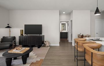 Killeen apartment for rent - A modern living room with a black sofa and a wooden coffee table.