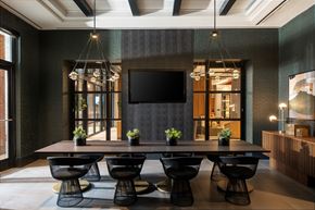 Mclean apartment for rent - A modern dining room with a long table and chairs.