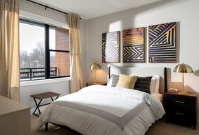 Mclean apartment for rent - A bedroom with a large bed and a window with curtains.