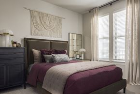 Princeton apartment for rent - A bedroom with a large bed and a window with white curtains.