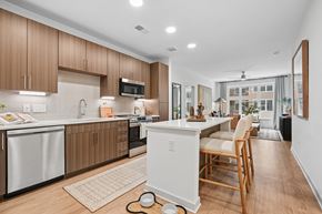 Charlotte apartment for rent - A modern kitchen with wooden cabinets and a white island.