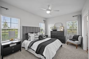 Perrysburg apartment for rent - Spacious primary bedroom featuring plush carpeting, large windows, and a bright, relaxing atmosphere.
