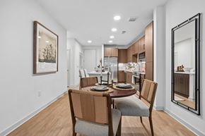 Charlotte apartment for rent - A modern dining room with a wooden table and chairs.